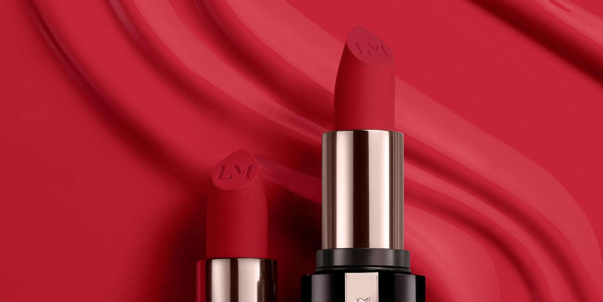 Image of Laura Mercier Caviar Creme Lipstick with a red background